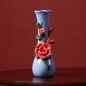 Blue handmade ceramic vase with rose